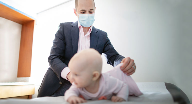 Image of doctor examining baby